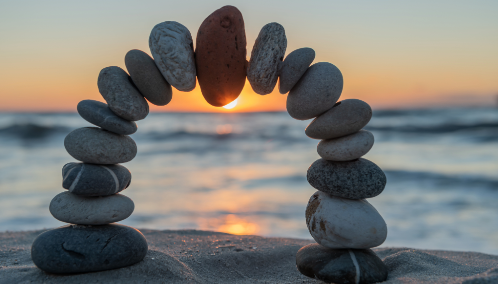 Stones in beach balanced to form an arc 