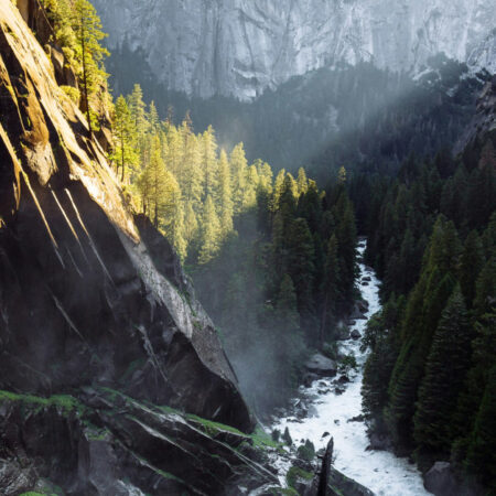 Mountain with gap and stream and light shining on one side of mountain