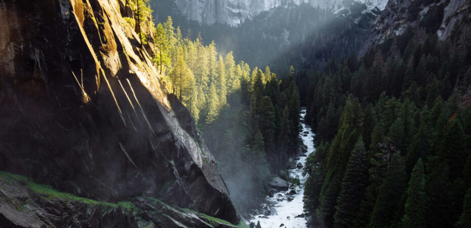 Mountain with gap and stream and light shining on one side of mountain