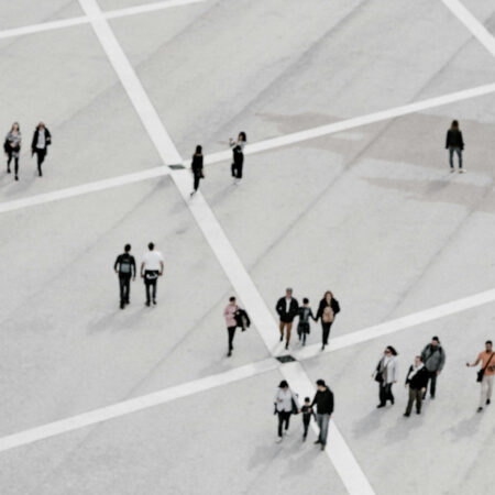 Image of people walking over large grid from a distance