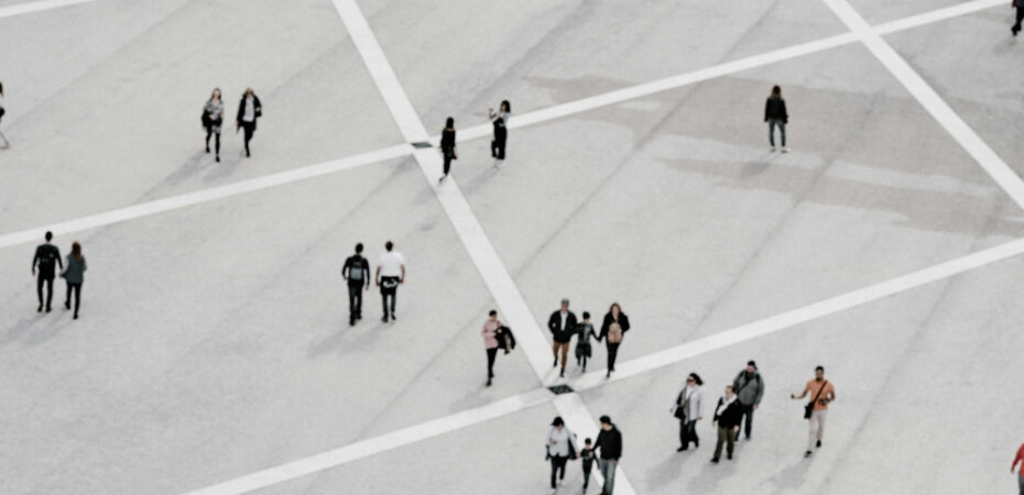 Image of people walking over large grid from a distance