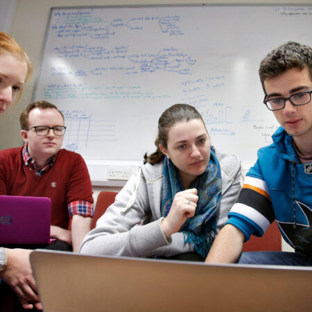 Students gathered around laptops