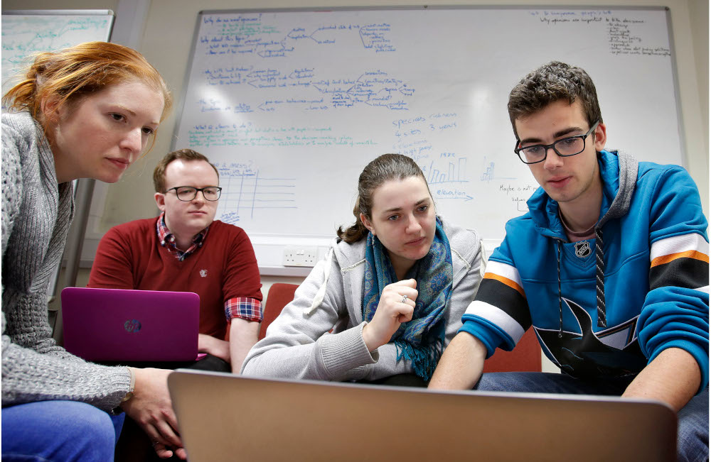 Students gathered around laptops