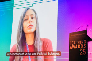 Photo of Nishat on video screen on centre stage accepting award virtually
