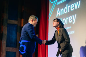 Photo of Andrew Storey receiving his award on stage