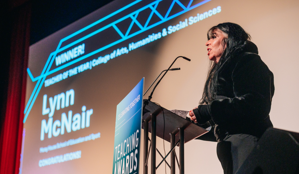 Photo of Lynn receiving her award on stage.