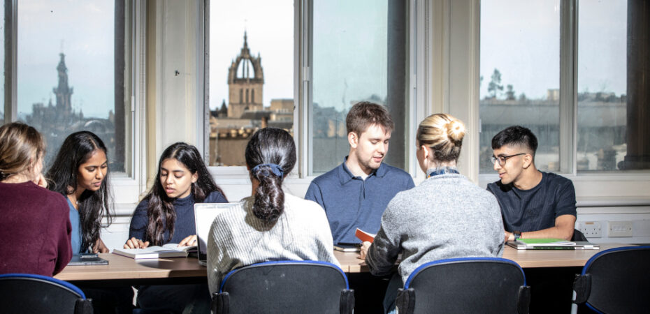 Students studying around a table in the Old Medical School.