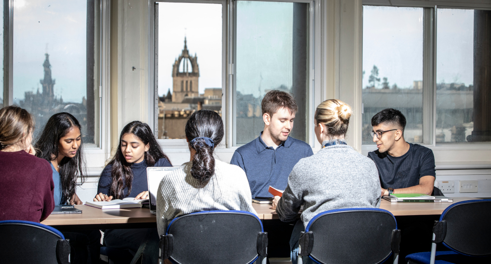 Students studying around a table in the Old Medical School.