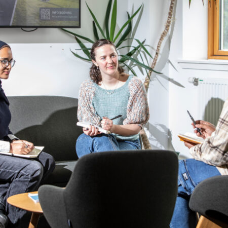 Students sitting around chatting in a building