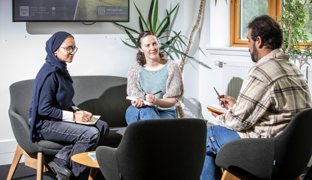 Students sitting around chatting in a building