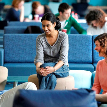 students and lecturer talking in informal space