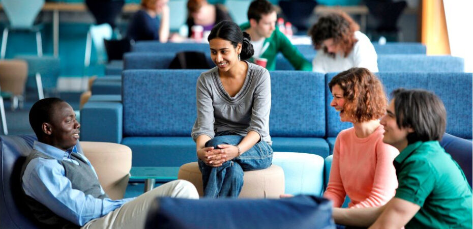 students and lecturer talking in informal space