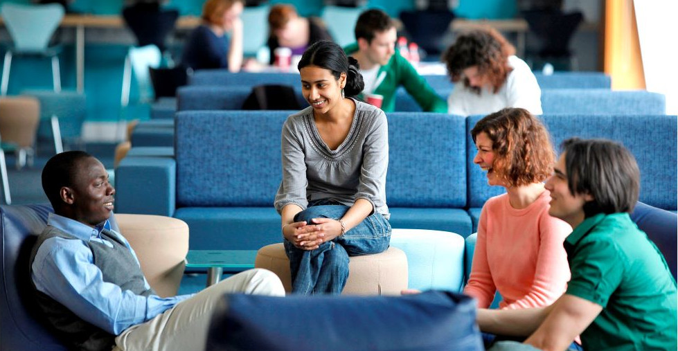 students and lecturer talking in informal space
