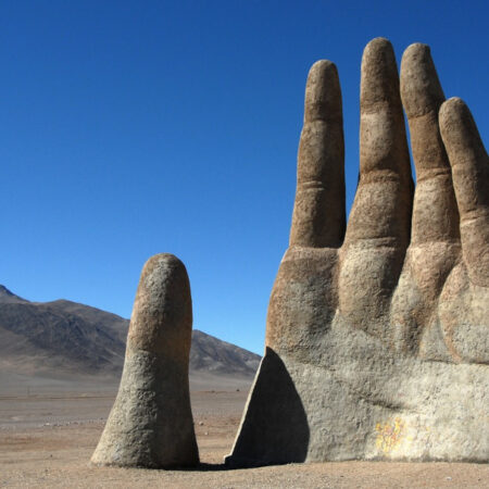 Photo of a hand sculpture emerging from the Atacama desert, Chile.