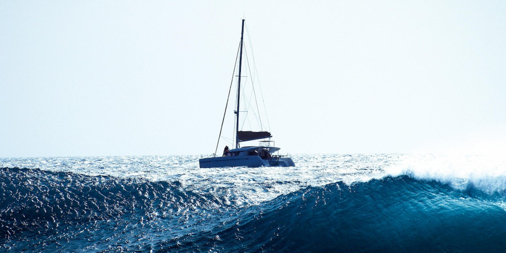 Photo of sail boat in wavy seas
