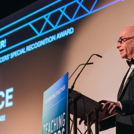 Photo of Stephen Warrington accepting Teaching Award on behalf of Tom Bruce