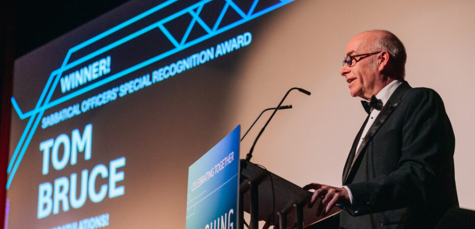 Photo of Stephen Warrington accepting Teaching Award on behalf of Tom Bruce