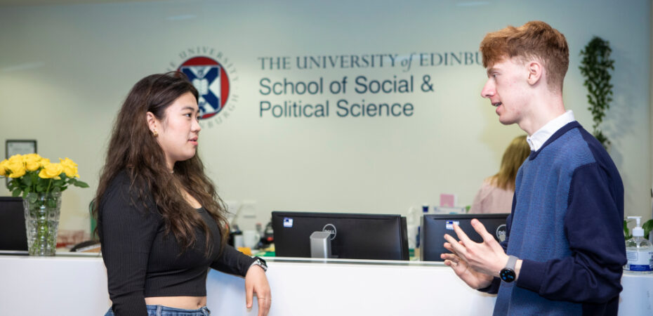 Students talking by reception in the Chrystal Macmillan building, School of Social and Political Science.