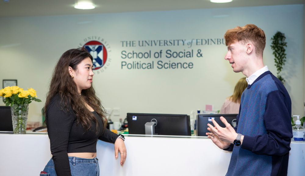 Students talking by reception in the Chrystal Macmillan building, School of Social and Political Science.