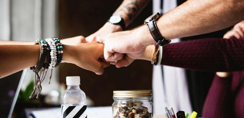Photo of people reaching out to fist-pump