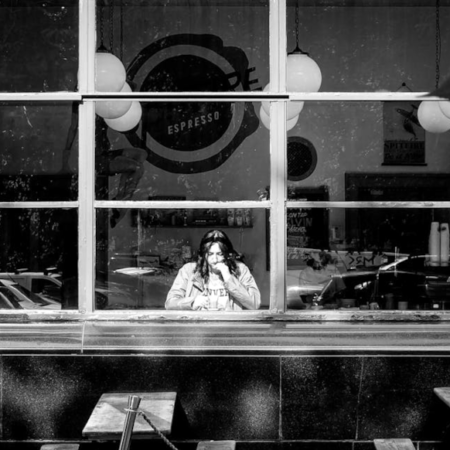 Black and white image of women drinking coffee in cafe in Glasgow
