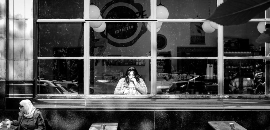 Black and white image of women drinking coffee in cafe in Glasgow