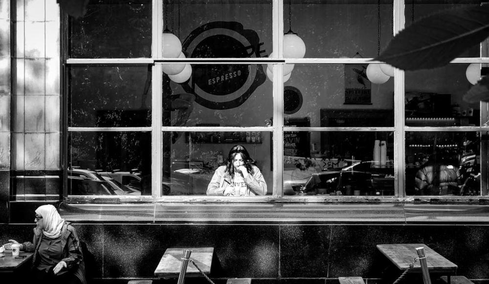 Black and white image of women drinking coffee in cafe in Glasgow