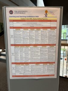 Photo of big print out of conference schedule on posterboard