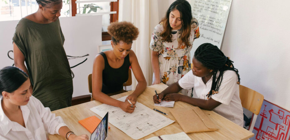 Group of women around a table working on a task