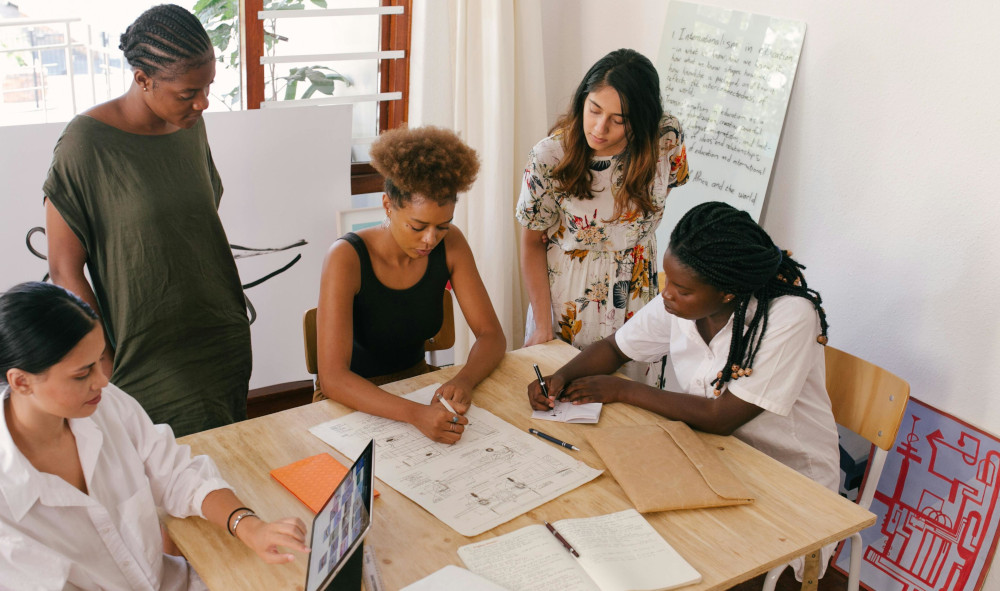 Group of women around a table working on a task