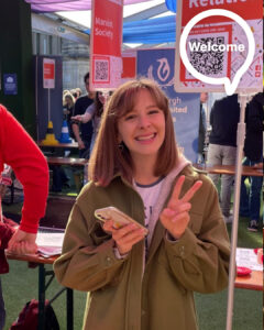 Photo of Lauren McDougall standing at the Activities Fair in Welcome Week.