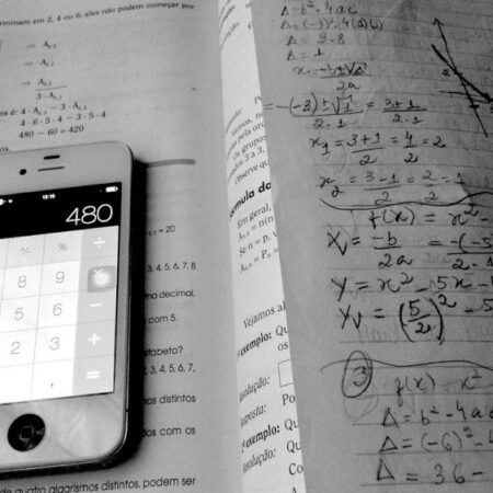 Photo of calculator lying on a maths workbook