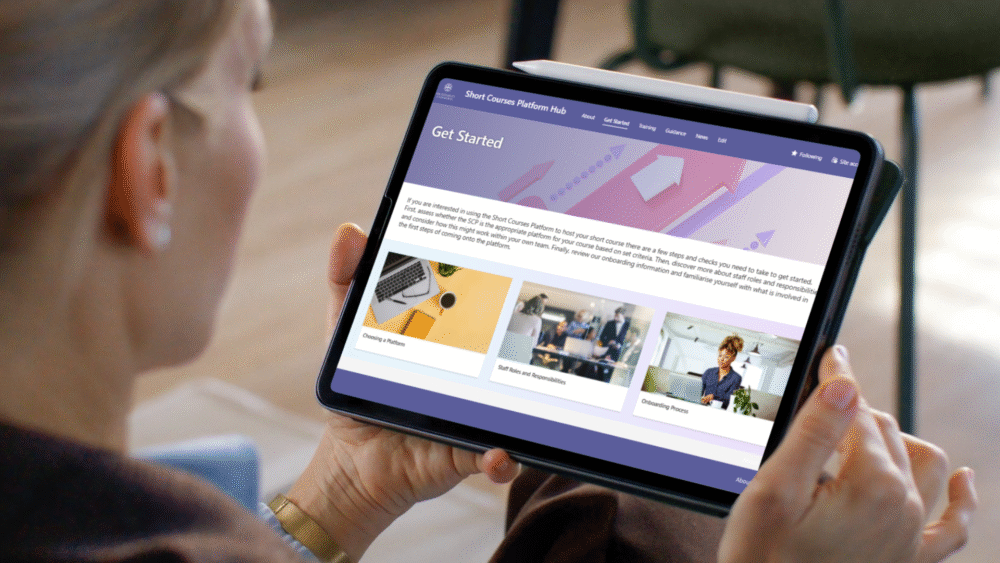 photo of someone looking on tablet with Short Course Platform Hub on screen