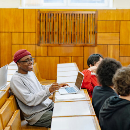 Group of students chatting in lecture hall