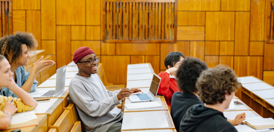 Group of students chatting in lecture hall