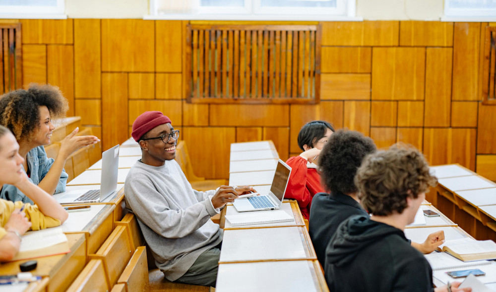 Group of students chatting in lecture hall