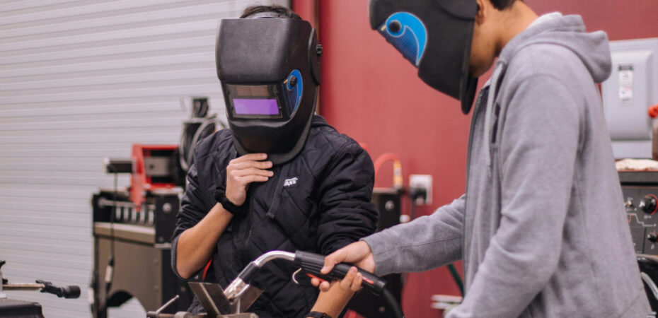 Photo of two people welding