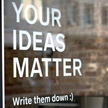 Window with words 'Your ideas matter - Write them down :)' written in white