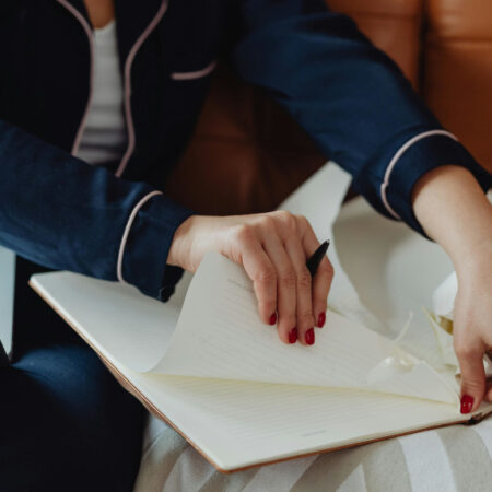 Person tearing paper from a note book