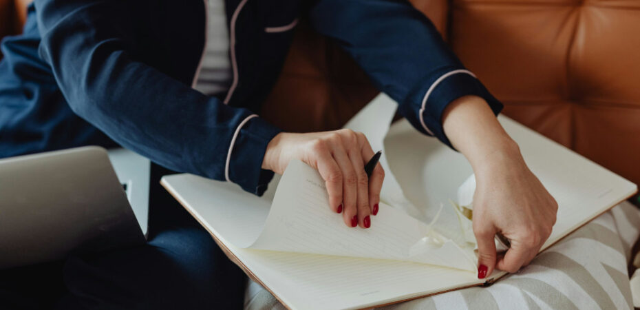 Person tearing paper from a note book