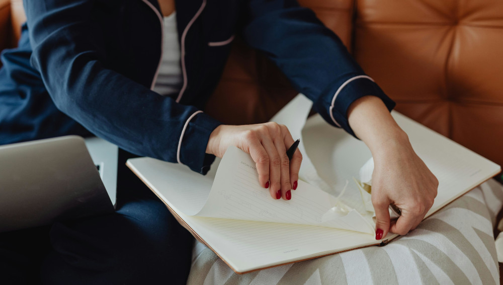 Person tearing paper from a note book