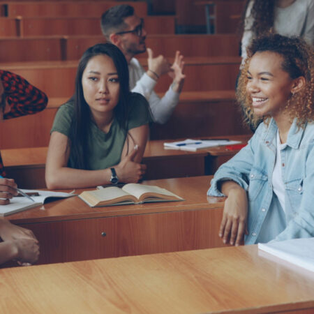 Students chatting together in a lecture hall