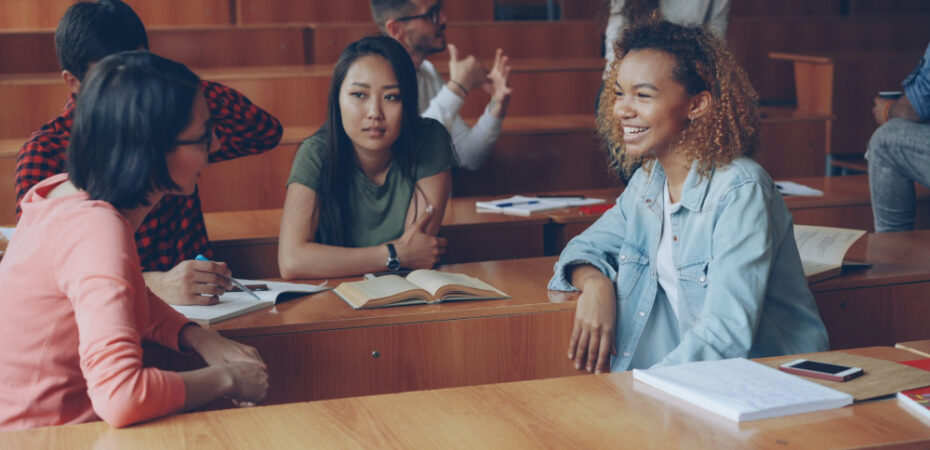 Students chatting together in a lecture hall