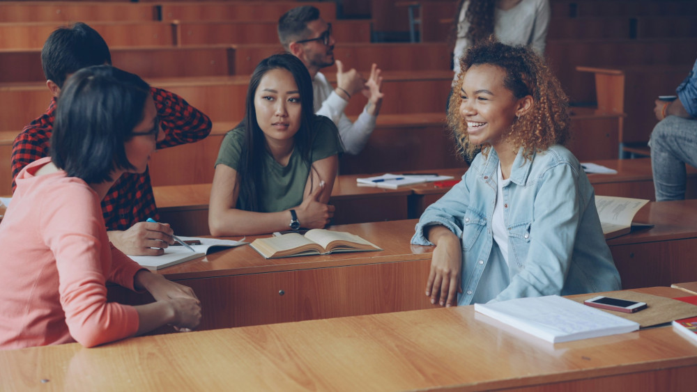 Students chatting together in a lecture hall