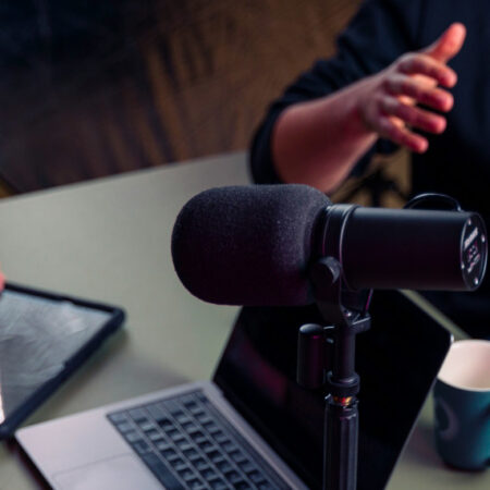 Photo of two people making a podcast