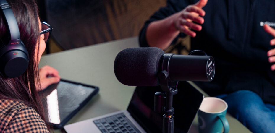 Photo of two people making a podcast