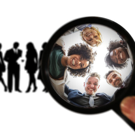 image of line of people silhouetted with magnifying glass bringing 5 people into focus
