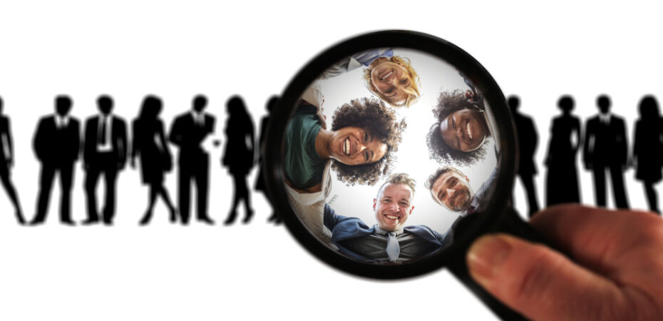 image of line of people silhouetted with magnifying glass bringing 5 people into focus