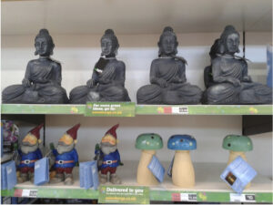 an image showing a supermarket shelf of buddha statues and garden gnomes