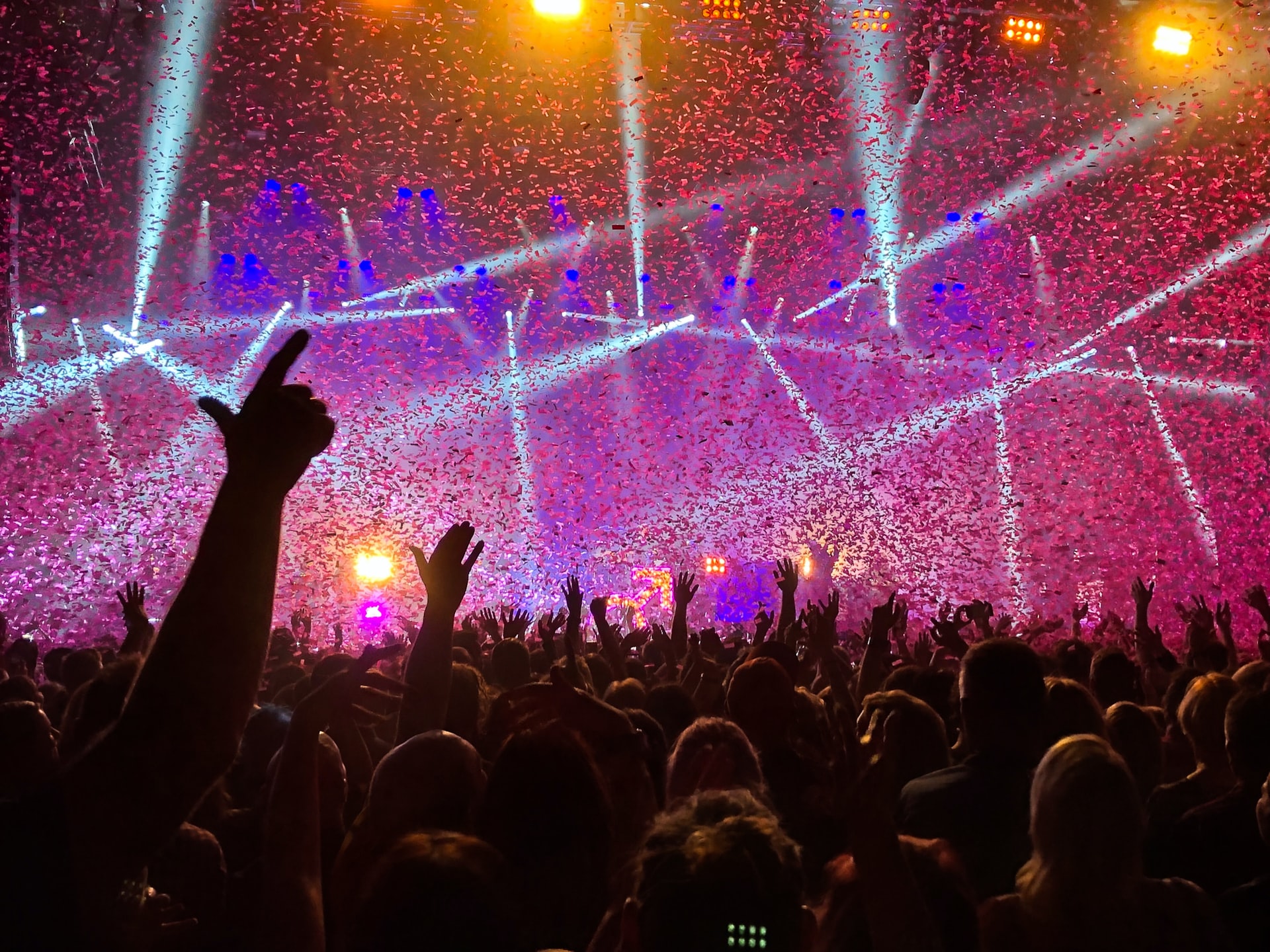 Concert scene of crowd, lights and confetti.